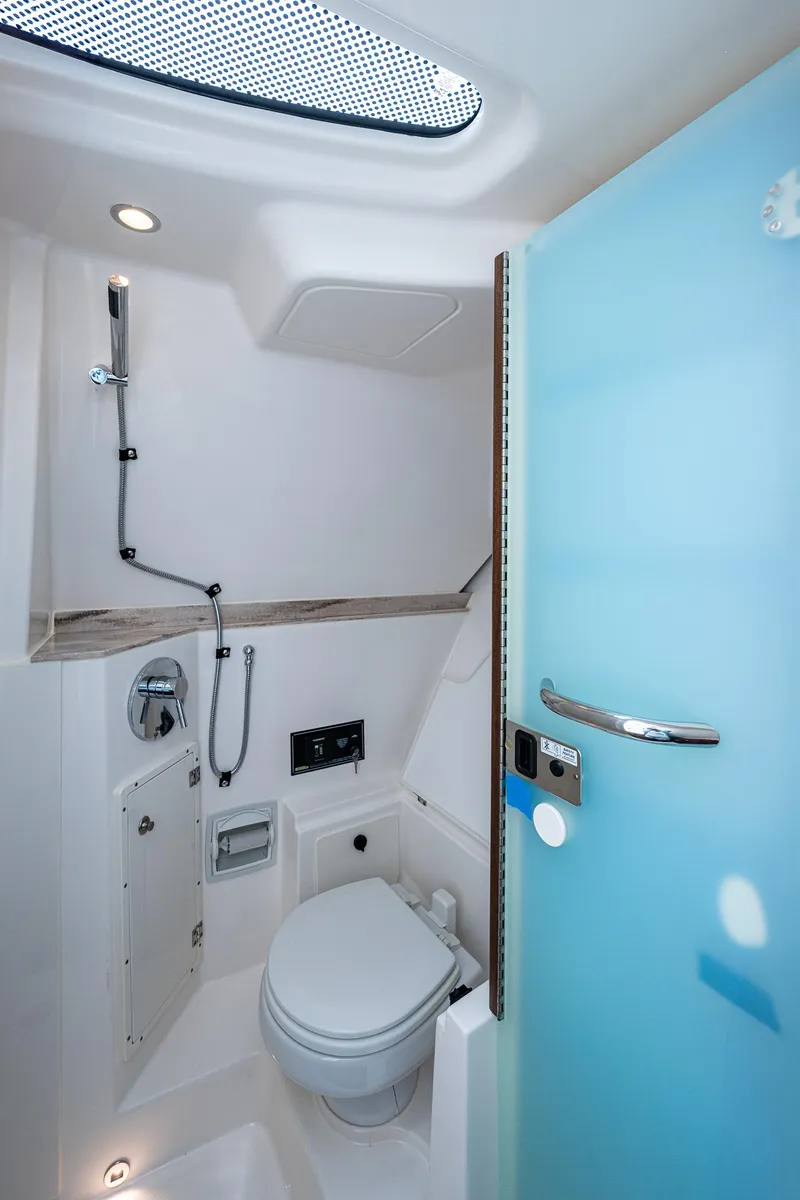 Slide: The Image of 2023 Pursuit DC 365 Dual Console boat bathroom with modern fixtures and skylight. - 37