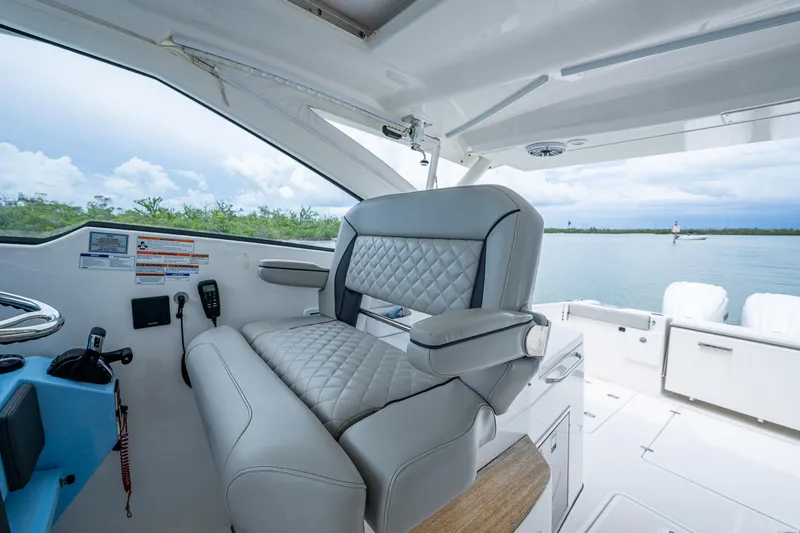Slide: The Image of 2023 Pursuit DC 365 Dual Console boat interior with luxurious seating and scenic water view. - 44