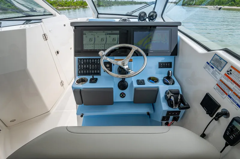 Slide: The Image of 2023 Pursuit DC 365 Dual Console helm with modern controls and navigation screens. - 45
