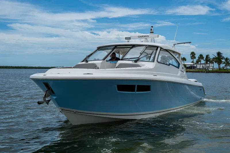 Slide: The Image of 2023 Pursuit DC 365 Dual Console boat cruising on a sunny day. - 48