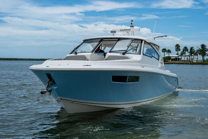 Slide: The Image of 2023 Pursuit DC 365 Dual Console boat cruising on a sunny day. - 49