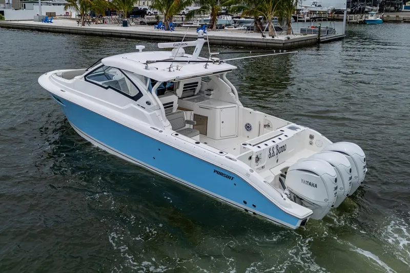 Slide: The Image of 2023 Pursuit DC 365 Dual Console boat with triple Yamaha engines on the water. - 5