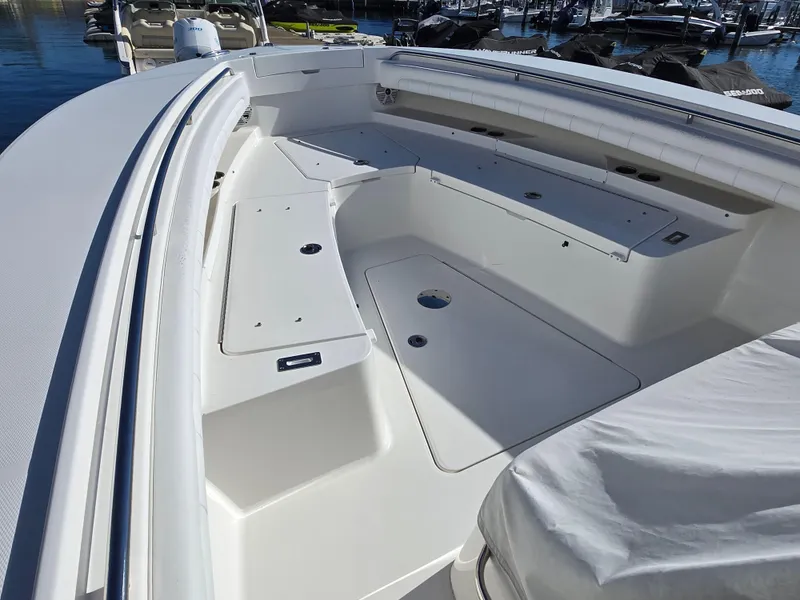 Slide: The Image of 2017 Regulator 28 boat interior with spacious seating and storage compartments. - 10