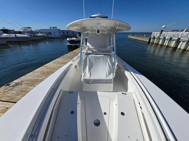 Slide: The Image of 2017 Regulator 28 boat docked at marina, clear sky, calm water. - 13