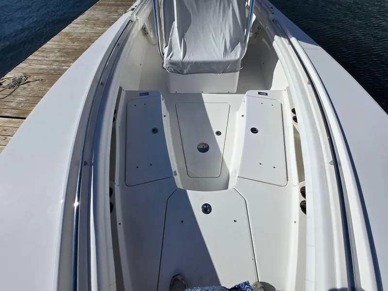 Slide: The Image of 2017 Regulator 28 boat deck with seating, docked by the water. - 14