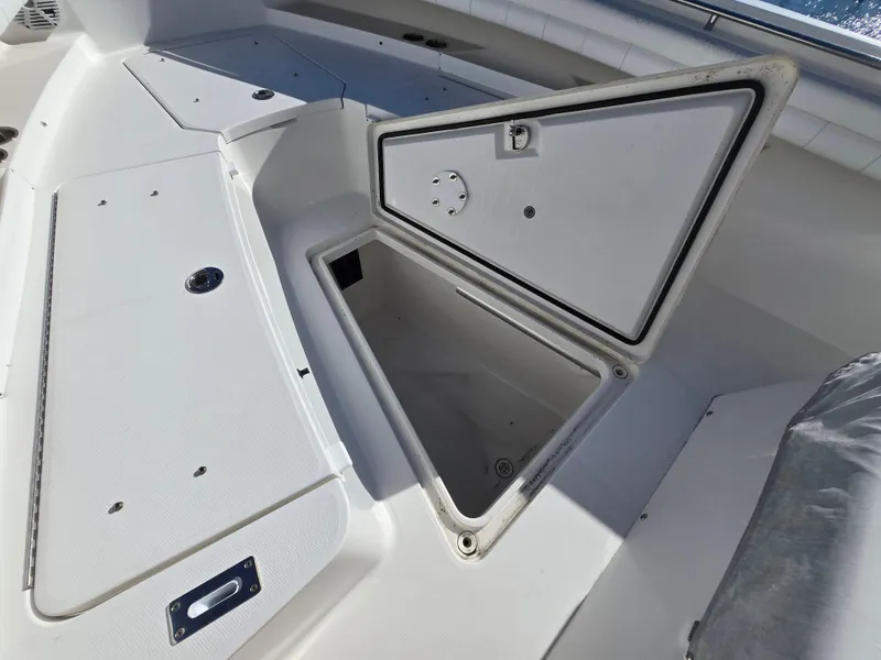 Slide: The Image of 2017 Regulator 28 boat storage compartment open on deck. - 15