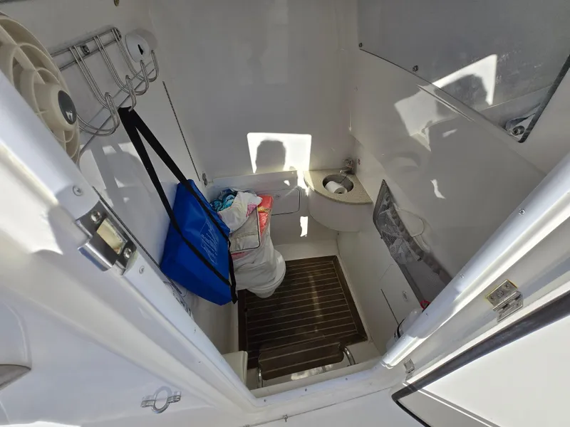 Slide: The Image of 2017 Regulator 28 boat interior with storage, sink, and wooden floor. - 18