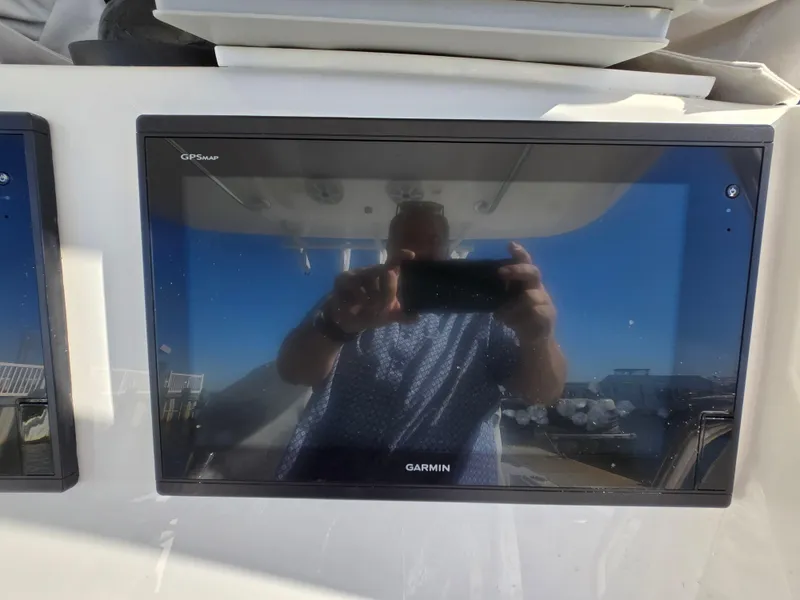 Slide: The Image of Garmin GPS display on 2017 Regulator 28 boat, reflecting a person taking a photo. - 22
