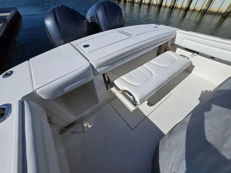 Slide: The Image of 2017 Regulator 28 boat with dual engines and white seating at the dock. - 24