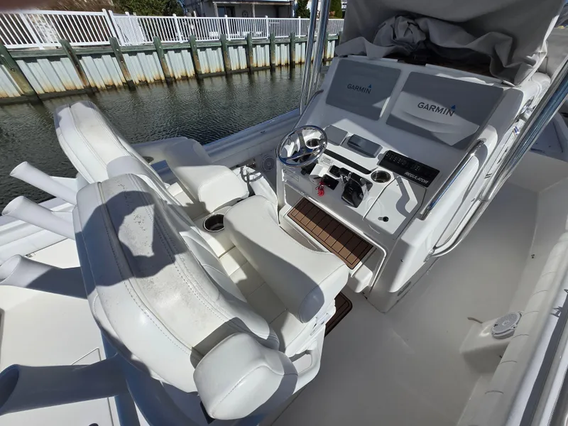Slide: The Image of 2017 Regulator 28 boat cockpit with Garmin navigation system and white seating. - 26