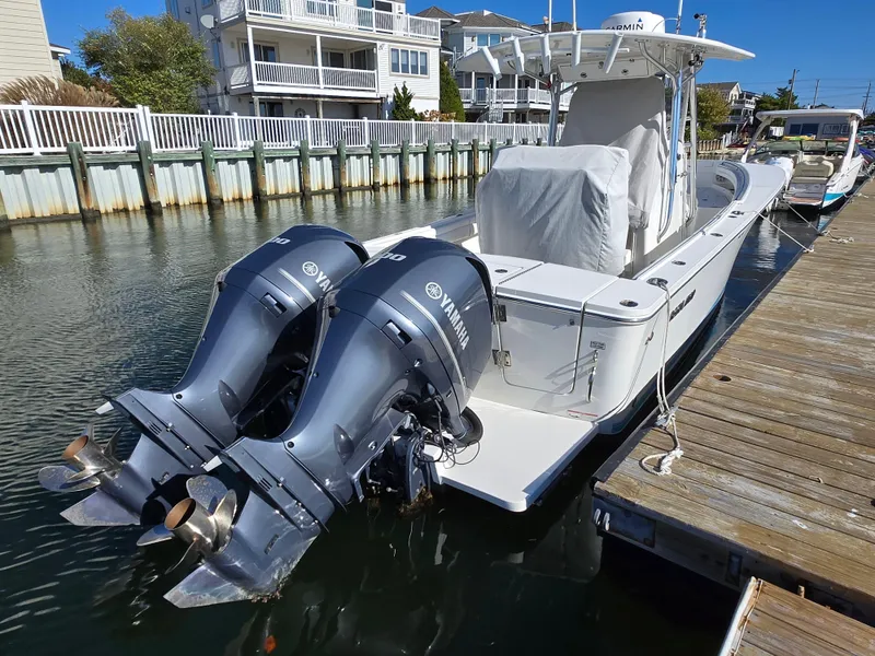 Slide: The Image of 2017 Regulator 28 boat docked with twin Yamaha outboard engines. - 3