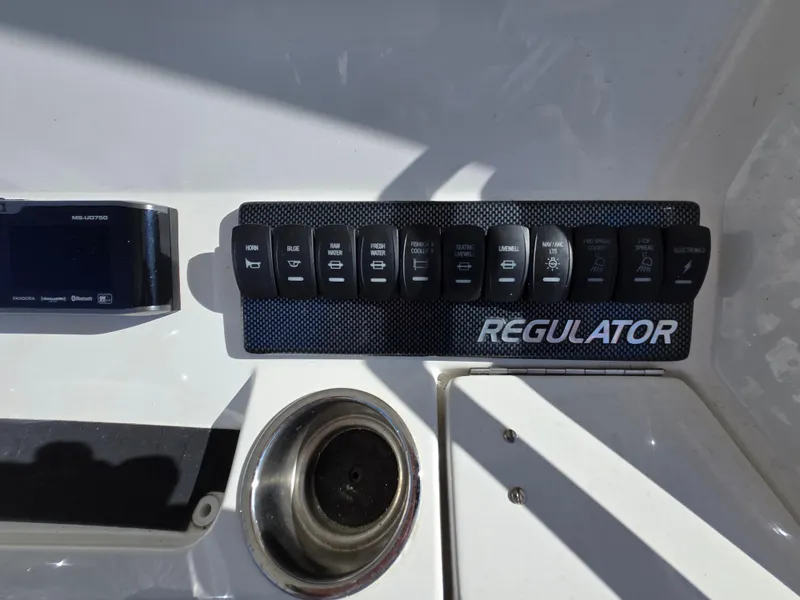 Slide: The Image of Control panel of a 2017 Regulator 28 boat with labeled switches. - 32