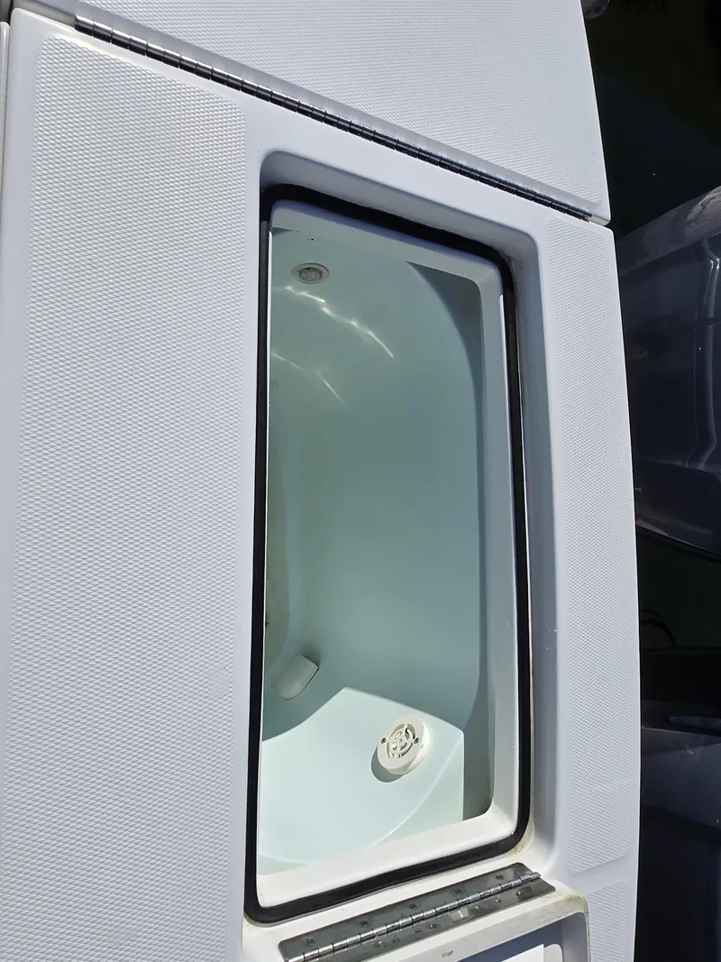 Slide: The Image of Livewell compartment on a 2017 Regulator 28 boat, featuring a clean interior. - 35