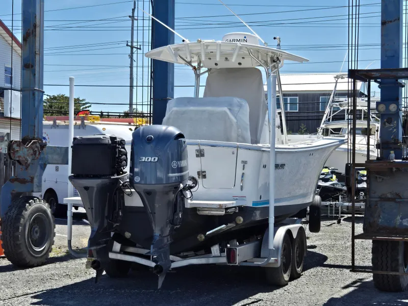 Slide: The Image of 2017 Regulator 28 boat with Yamaha 300 engine on a trailer in a marina. - 36