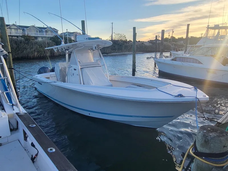 Slide: The Image of 2017 Regulator 28 boat docked at marina during sunset. - 4