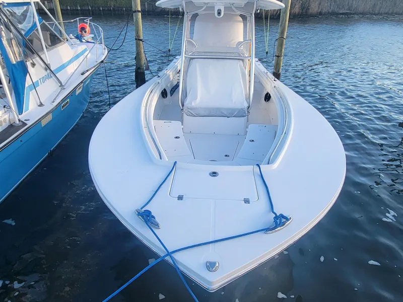 Slide: The Image of 2017 Regulator 28 boat docked, featuring sleek design and spacious deck. - 5