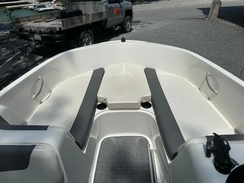 Slide: The Image of 2019 Bayliner Element E16 boat interior with seating and cup holders. - 10