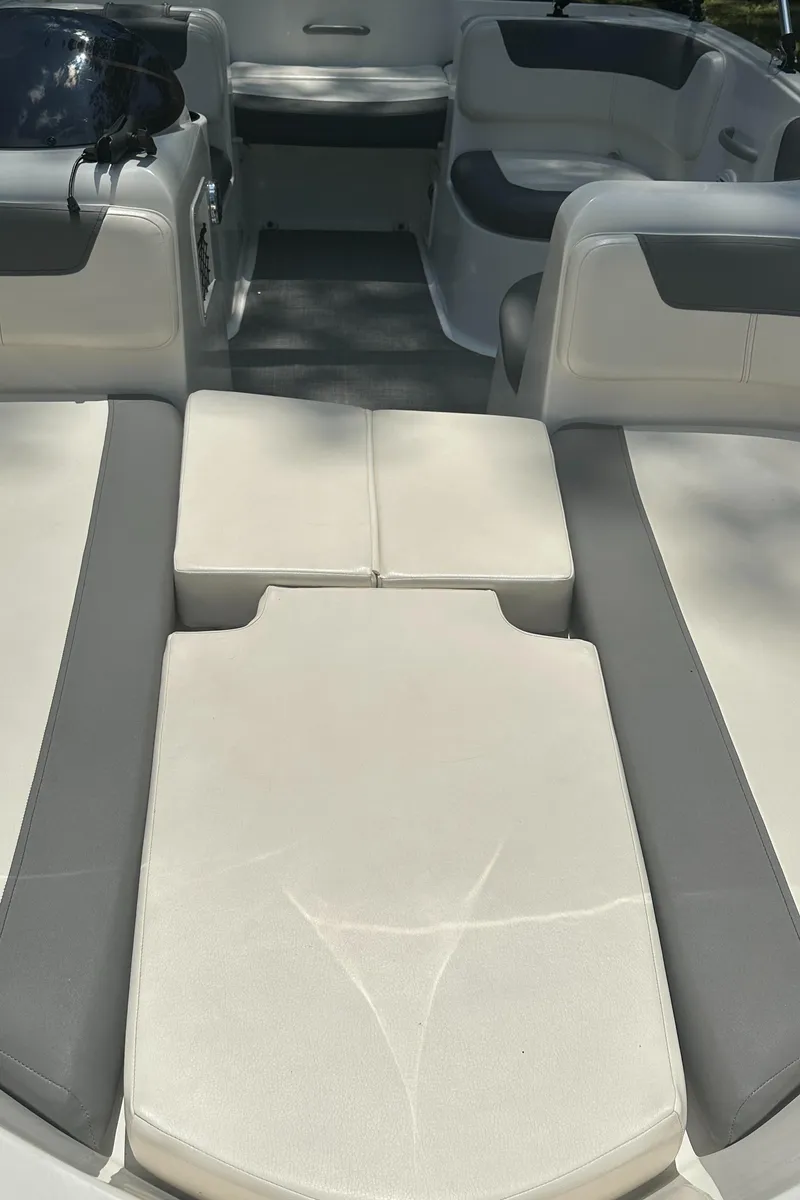 Slide: The Image of 2019 Bayliner Element E16 boat interior with cushioned seating and storage areas. - 15