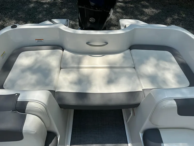 Slide: The Image of 2019 Bayliner Element E16 boat interior with cushioned seating and sleek design. - 7