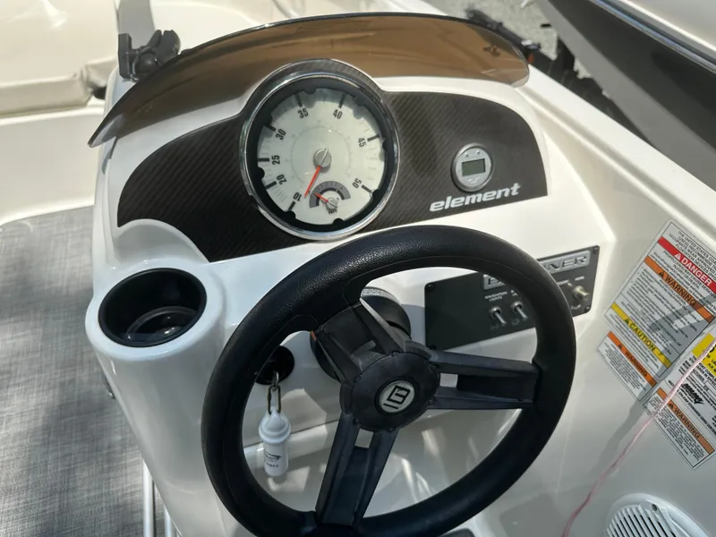 Slide: The Image of 2019 Bayliner Element E16 dashboard with steering wheel and speedometer. - 8