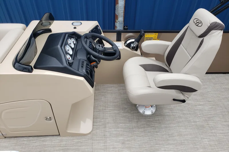 Slide: The Image of 2026 Bentley Pontoons Legacy 243 Cruise helm with luxurious captain's chair and control panel. - 13