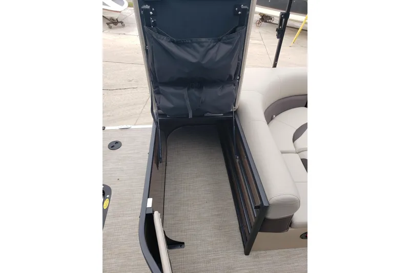 Slide: The Image of 2026 Bentley Pontoons Legacy 243 Cruise interior storage compartment open, showcasing seating and flooring. - 17