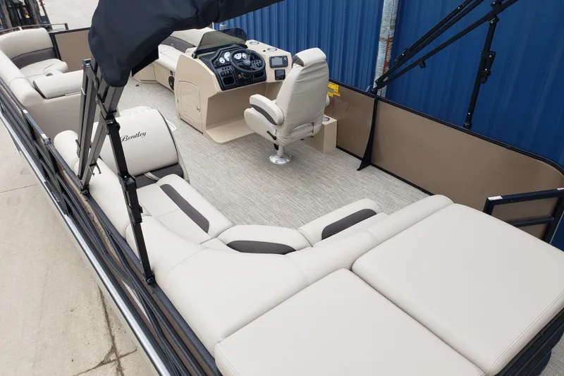 Slide: The Image of 2026 Bentley Pontoons Legacy 243 Cruise interior with plush seating and modern helm. - 7