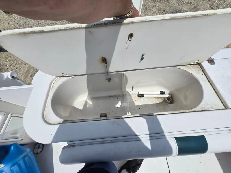 Slide: The Image of Open storage compartment on a 1995 Pro-Line 240 Center Console boat. - 12
