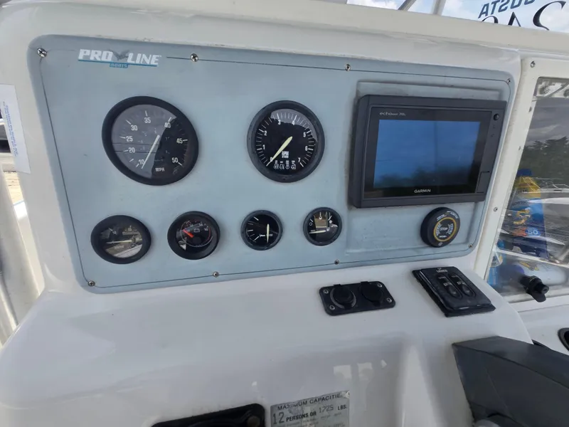 Slide: The Image of 1995 Pro-Line 240 Center Console dashboard with gauges and Garmin display. - 15