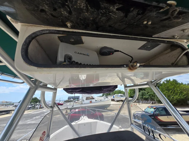 Slide: The Image of 1995 Pro-Line 240 Center Console boat with Garmin equipment, docked at a marina. - 18