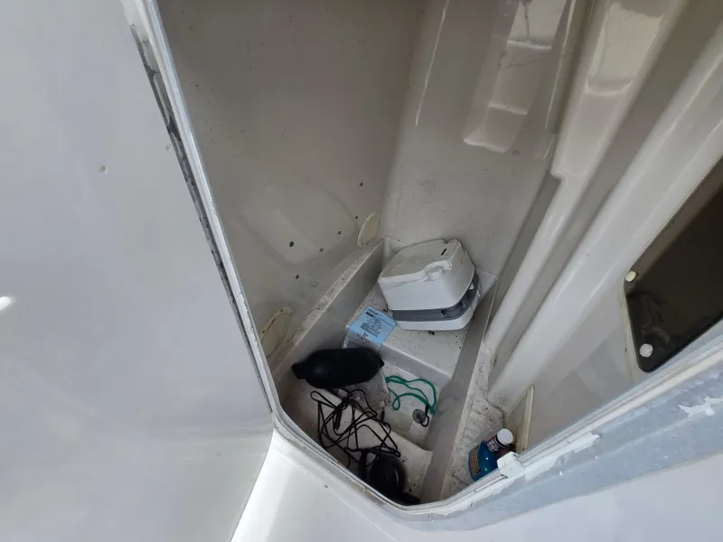Slide: The Image of Interior of a 1995 Pro-Line 240 Center Console boat with various items stored. - 23