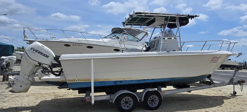 Slide: The Image of 1995 Pro-Line 240 Center Console boat with Evinrude motor on trailer, for sale. - 4