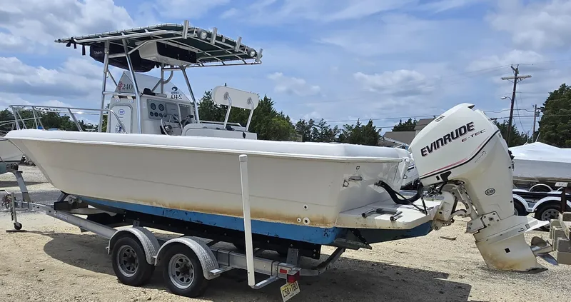 Slide: The Image of 1995 Pro-Line 240 Center Console boat on trailer with Evinrude outboard motor. - 7