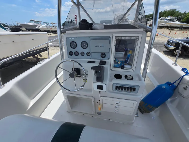 Slide: The Image of 1995 Pro-Line 240 Center Console boat dashboard with steering wheel and navigation equipment. - 9
