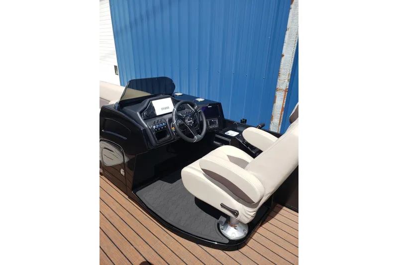 Slide: The Image of 2026 Bentley Pontoons Elite 253 QSB helm with modern controls and beige seating. - 11