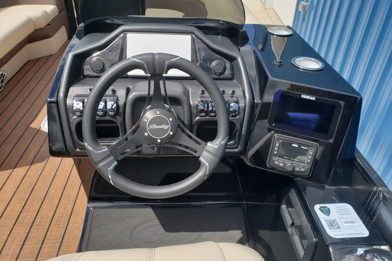 Slide: The Image of Steering console of 2026 Bentley Pontoons Elite 253 QSB with modern controls and display. - 12