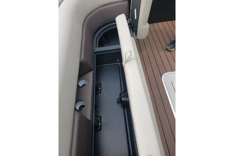 Slide: The Image of 2026 Bentley Pontoons Elite 253 QSB interior storage compartment with cup holders and seating. - 15