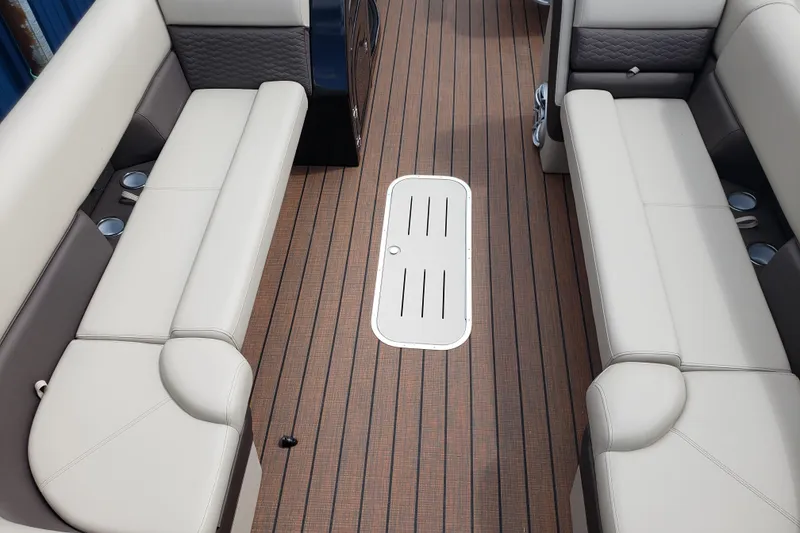 Slide: The Image of Interior of 2026 Bentley Pontoons Elite 253 QSB with beige seating and wood flooring. - 16