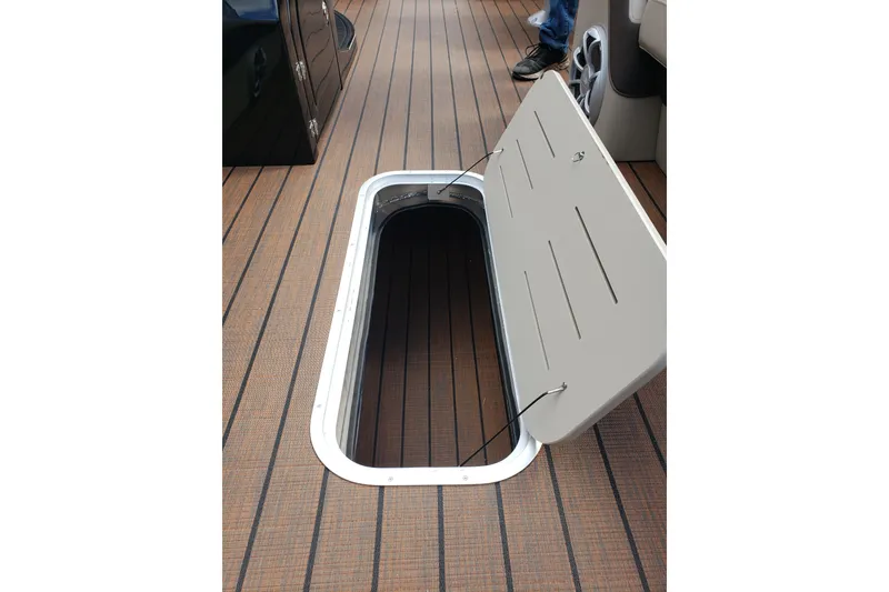 Slide: The Image of Open storage compartment on 2026 Bentley Pontoons Elite 253 QSB boat deck. - 17