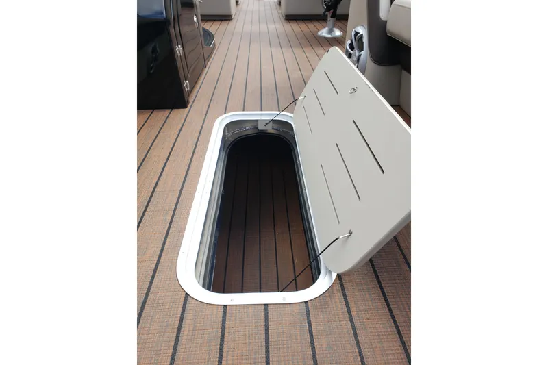 Slide: The Image of Open storage compartment on 2026 Bentley Pontoons Elite 253 QSB deck. - 18