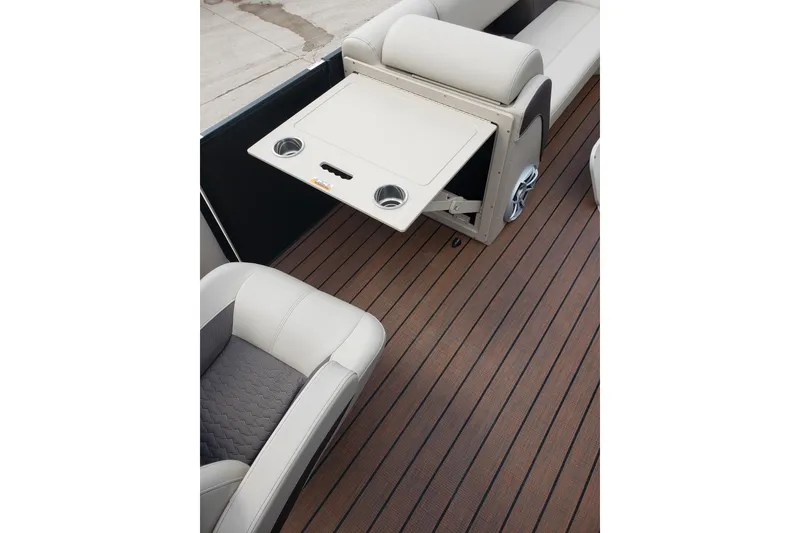 Slide: The Image of 2026 Bentley Pontoons Elite 253 QSB interior with foldable table and cup holders. - 20