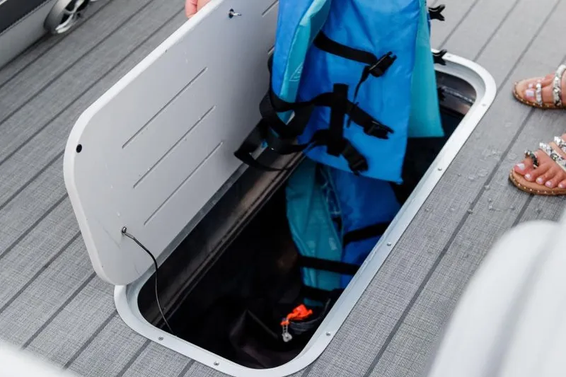Slide: The Image of Storage compartment on 2025 Bentley Pontoons Elite 253 QSB with life jackets. - 4