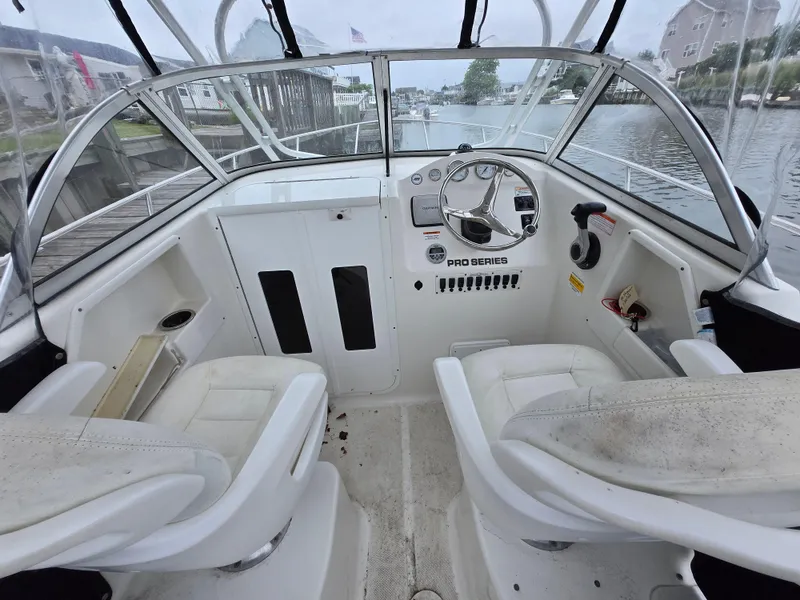 Slide: The Image of 2010 Sea Fox 216 Walk Around boat interior with steering wheel and seating. - 6
