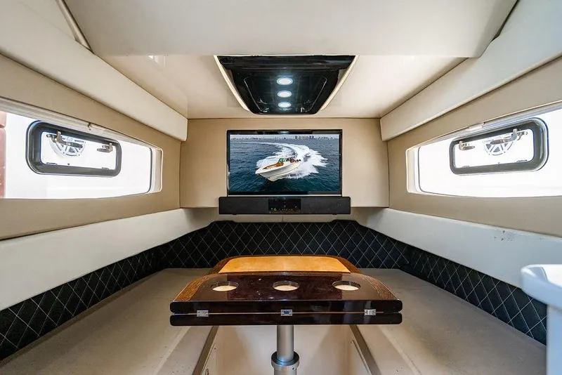 Slide: The Image of Luxurious interior of 2018 Scout 420 LXF boat with TV and seating area. - 22