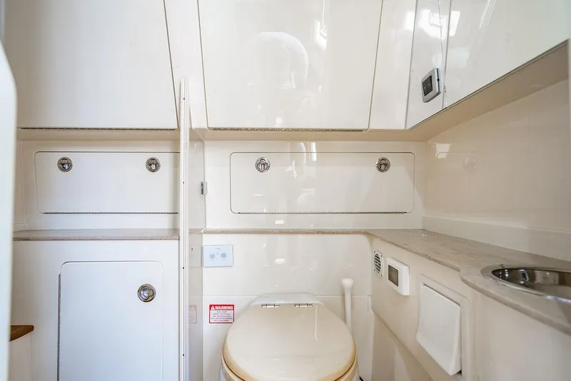 Slide: The Image of Luxurious bathroom interior of 2018 Scout 420 LXF boat, featuring sleek cabinetry and modern fixtures. - 27