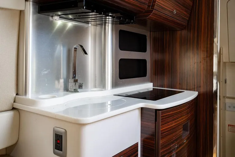 Slide: The Image of Luxurious 2018 Scout 420 LXF yacht kitchen with modern sink and sleek wood cabinetry. - 29