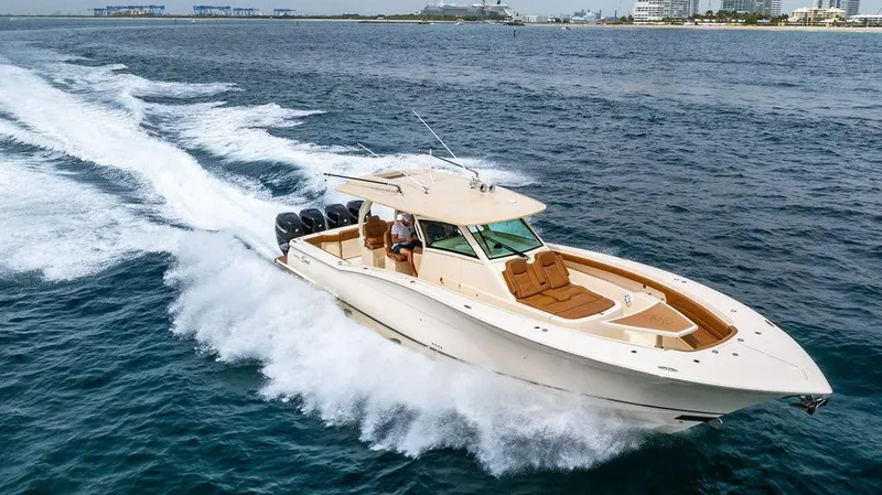 Slide: The Image of 2018 Scout 420 LXF boat cruising on open water, showcasing luxury and performance. - 3