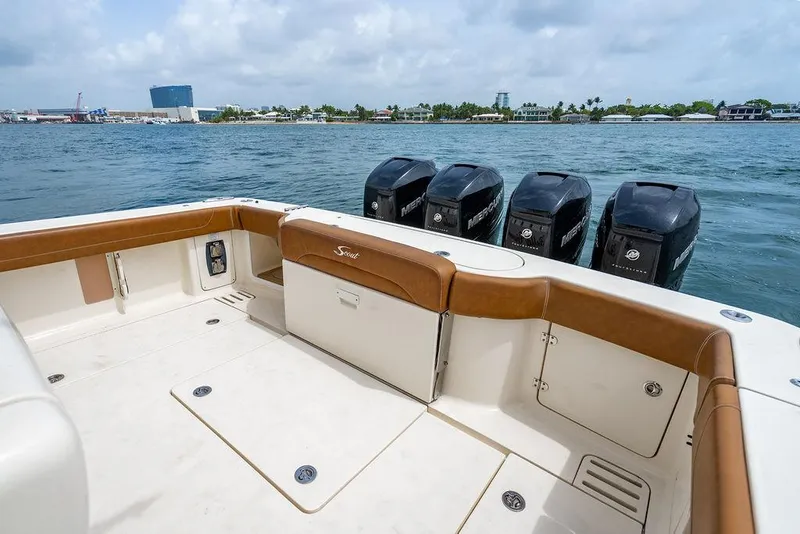 Slide: The Image of 2018 Scout 420 LXF boat with multiple outboard engines on a calm waterway. - 31