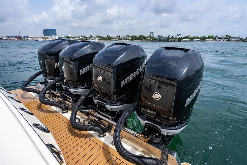 Slide: The Image of Four Mercury outboard engines on a 2018 Scout 420 LXF boat in the water. - 35