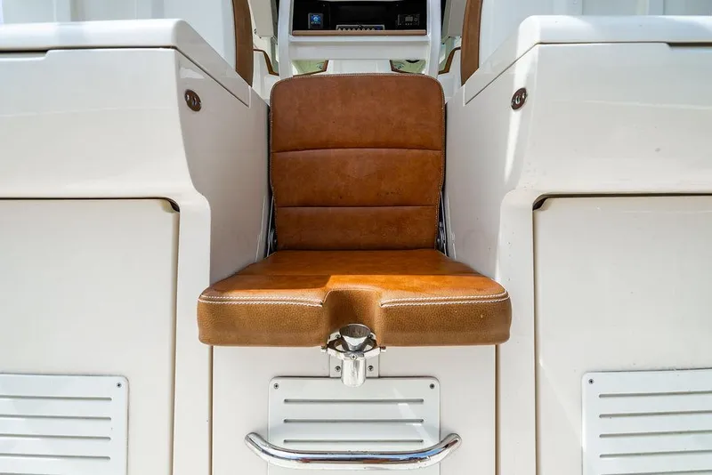 Slide: The Image of Brown leather seat on 2018 Scout 420 LXF boat interior. - 37
